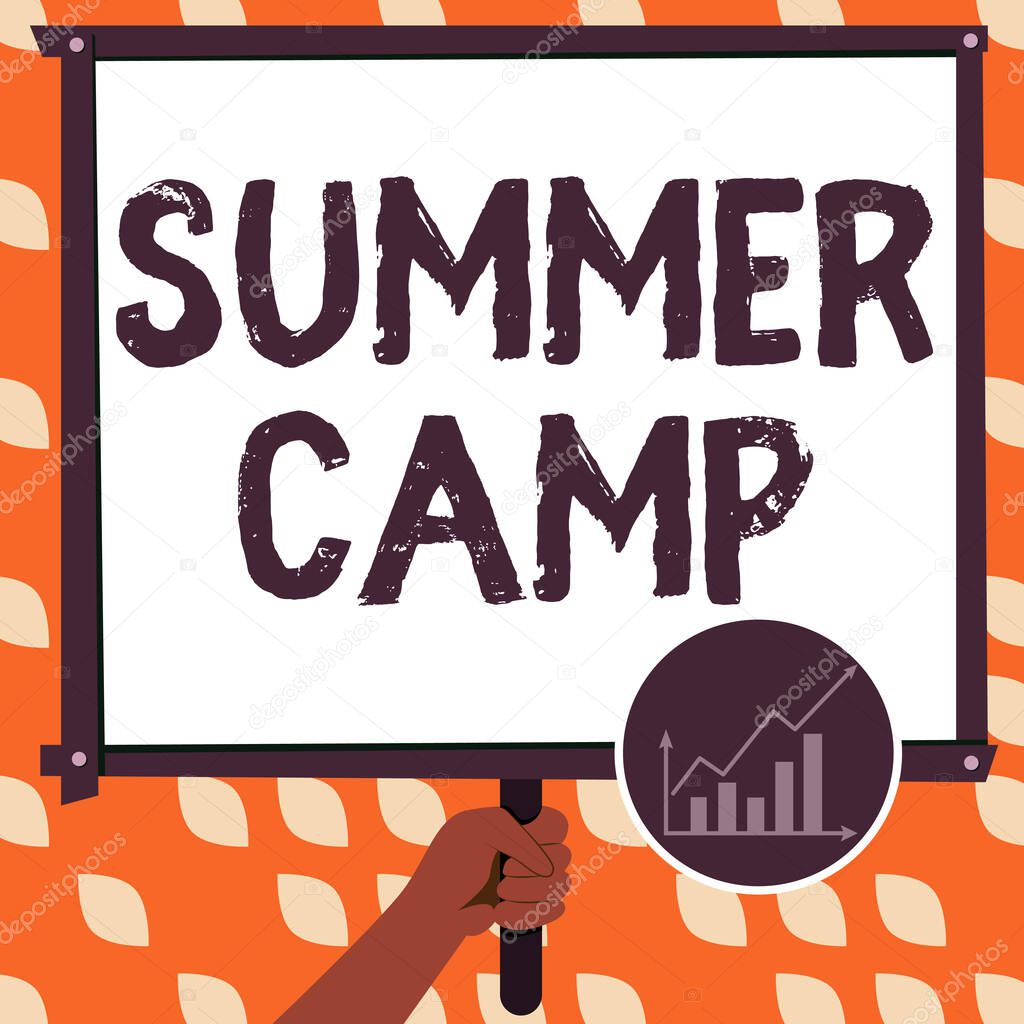 Text showing inspiration Summer Camp, Word Written on Supervised program for kids and teenagers during summertime. Hand Holding Panel Board Displaying Latest Financial Growth Strategies.