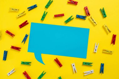 Colorful Pegs Placed Around Speech Bubble With Important Information.