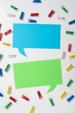 Pegs Placed Around Two Speech Bubbles With Important Information.