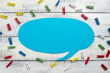 Colorful Pegs Placed Around Speech Bubble With Important Information.