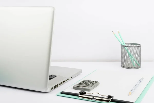 Lap Top, Empty Clipboard With Paper, Cup With Pencils And Calculator.