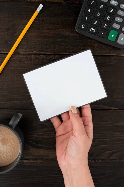 Hand Of Woman With Blank Paper, Coffee Cup And Stationery Over Wood.