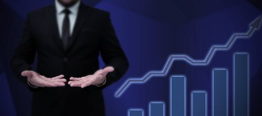 Takım elbiseli kadın elinde kalem tutarak başarılı takım çalışmasını simgeliyor..