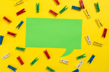 Colorful Pegs Placed Around Speech Bubble With Important Information.
