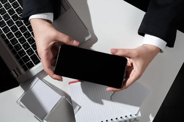 Businesswoman Presenting Important News On Mobile Phone Screen On Desk.