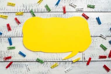 Colorful Pegs Placed Around Speech Bubble With Important Information.