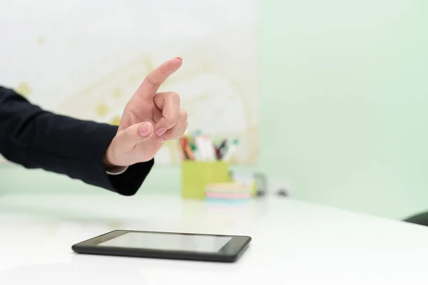 Businesswoman With Tablet On Desk Presenting New Ideas With One Finger.