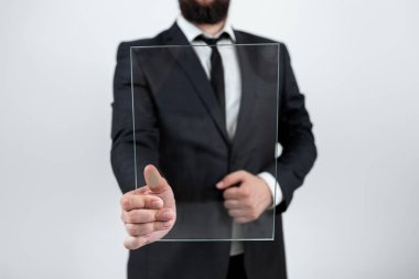 Businessman Pointing At Transparent Glass And Promoting The Brand.