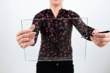 Woman Holding Pen And Glass Banner While Promoting The Company.