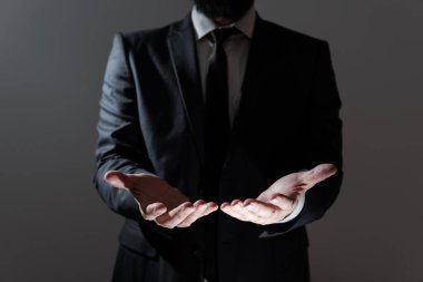 Businessman In Suit Holding Important Informations Above Hands.