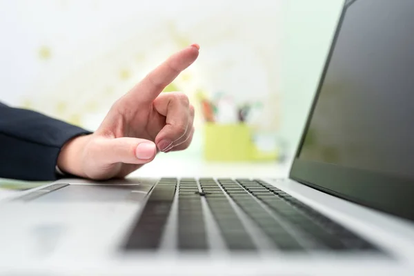 Woman With Lap Top On Desk Pointing Important Messages With One Finger.