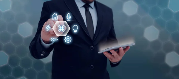 Man Holding Tablet And Pen Pointing On With Other Symbols Around.