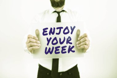 Text showing inspiration Enjoy Your Week, Business overview Best wishes for the start of weekdays have great days Businessman With Placard Presenting Important Strategies For Progress.