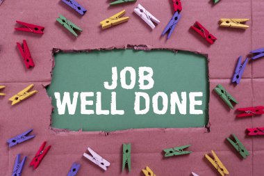 Handwriting text Job Well Done, Concept meaning Well Performed You did it Cheers Approval Par Accomplished Important Ideas Written Under Ripped Cardboard With Colored Pegs Around.
