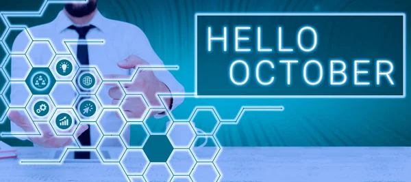 Text showing inspiration Hello October, Business showcase Last Quarter Tenth Month 30days Season Greeting Man With Touch Screen Displaying Digital Symbols With Creative Concepts.