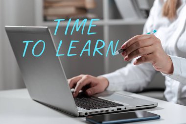 Text sign showing Time To Learn, Business showcase Obtain new knowledge or skill Educational or career growth Woman Typing Updates On Lap Top And Pointing New Ideas With Pen.