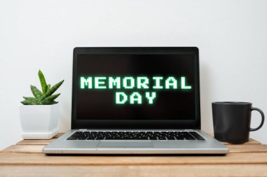 Handwriting text Memorial Day, Business approach To honor and remembering those who died in military service Lap Top With Important Information On Table With Plant And Cup Of Coffee.