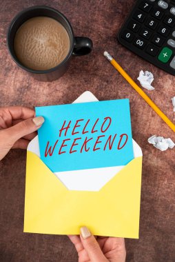 Handwriting text Hello Weekend, Business approach Getaway Adventure Friday Positivity Relaxation Invitation Woman Holding Blank Letter With Coffee And Stationery Over Wood.