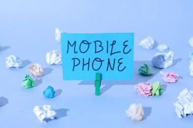 Sign displaying Mobile Phone, Internet Concept A handheld device used to send receive calls and messages Important Message Presented On Piece Of Paper Clipped With Clip.