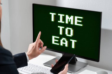 Text caption presenting Time To Eat, Conceptual photo Right moment to enjoy a meal lunch dinner good food starving Businesswoman Holding Mobile Phone And Pointing On Computer Screen.