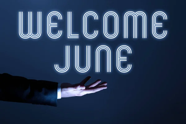 Text sign showing Welcome June, Conceptual photo Calendar Sixth Month Second Quarter Thirty days Greetings Businessman In Suit Holding Important Infortmations Over One Hand.