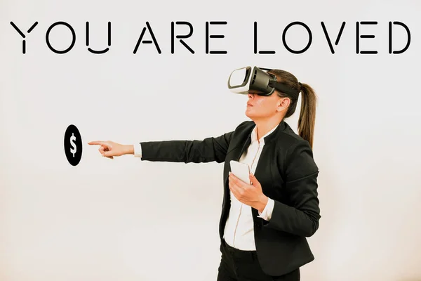 Text sign showing You Are Loved, Business concept Somebody loves you have strong feelings happy excited Woman Holding Mobile Phone, Wearing Vr Glasses And Pointing On New Idea.