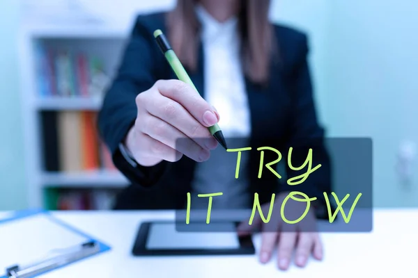 Text sign showing Try It Now, Business overview Free trial of something new experiment different things Businesswoman Having Tablet On Desk And Pointing New Ideas With Pen.