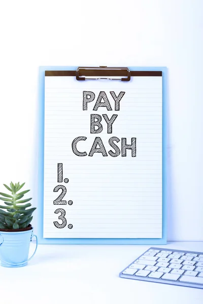 Text sign showing Pay By Cash, Business approach Customer paying with money coins bills Retail shopping Important Message Presented On Clipboard On Desk With Flower And Keyboard.