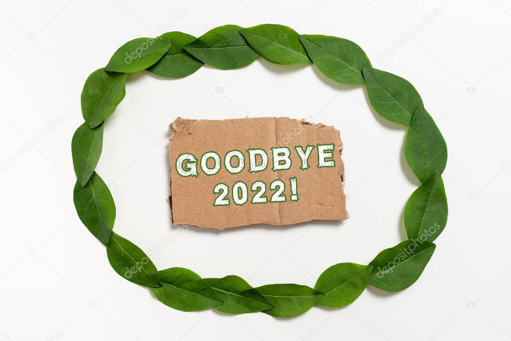 Writing displaying text Goodbye 2022, Word for New Year Eve Milestone Last Month Celebration Transition Blank Color Paper Between Leaves Wreath For Wedding Invitation.