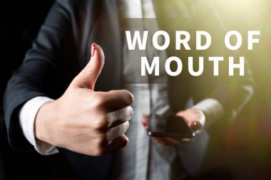 Hand writing sign Word Of Mouth, Business approach Oral spreading of information Storytelling Viva Voice Businesswoman Holding Cellphone In One Hand And Showing Thumbs Up.
