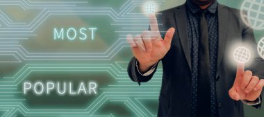 Handwriting text Most Popular, Word Written on Liked Followed Enjoyed by majority of the showing in a society Businessman Pointing With Two Fingers On S And Presenting New Ideas.