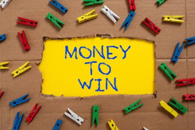 Text caption presenting Money To Win, Internet Concept Calculating revenues are going to be obtained doing something Important Ideas Written Under Ripped Cardboard With Colored Pegs Around.