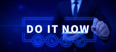 Text sign showing Do It Now, Business showcase Respond Immediately Something needs to be done right away Businessman in suit holding open palm symbolizing successful teamwork.