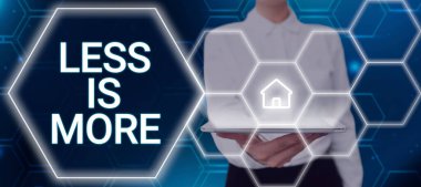 Text caption presenting Less Is More, Word Written on Minimalist approach to artistic matter is more effective Woman Holding A Pad With Homepage Giving Crucial Information.