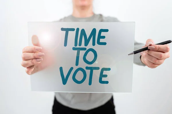 Hand writing sign Time To Vote, Conceptual photo Election ahead choose between some candidates to govern Woman Holding Pen And Placard Advertising Business For Growth.