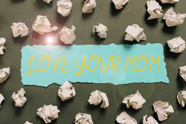 Conceptual caption Love Your Mom, Business approach Have good feelings about your mother Loving emotions Crumpled Notes Placed All Over Written Important Informations On Paper.