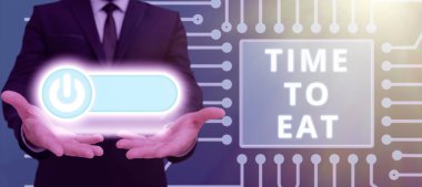 Conceptual display Time To Eat, Concept meaning Right moment to enjoy a meal lunch dinner good food starving Man Showing Hands With On Power Button Receiving Ideas And Messages.