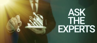 Text showing inspiration Ask The Experts, Internet Concept Look for a professional advice consultation support Businessman in suit holding open palm symbolizing successful teamwork.