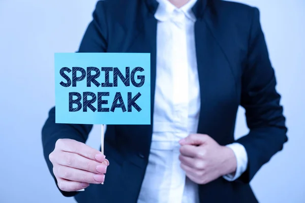 Text sign showing Spring Break, Business approach Vacation period at school and universities during spring Businesswoman Presenting Important Message On Paper Attached To Stick.