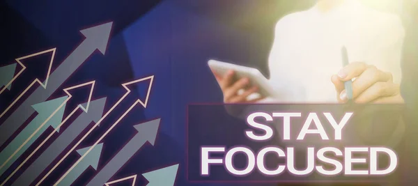 Text sign showing Stay Focused, Internet Concept Be attentive Concentrate Prioritize the task Avoid distractions Lady in suit holding pen symbolizing successful teamwork accomplishments.