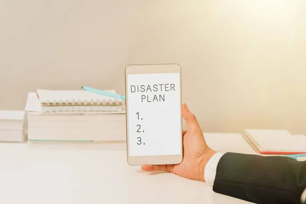 Text caption presenting Disaster Plan, Word Written on Respond to Emergency Preparedness Survival and First Aid Kit Sitting Businesswoman Holding Mobile Phone With Important Messages.
