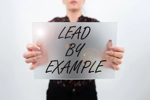 Writing displaying text Lead By Example, Conceptual photo Be a mentor leader follow the rules give examples Coach Woman Showing Placard And Presenting Important Ideas For Marketing.