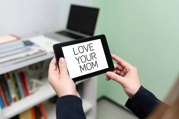 Inspiration showing sign Love Your Mom, Concept meaning Have good feelings about your mother Loving emotions Businesswoman Holding Tablet With Important Informations On It.