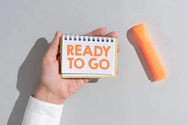 Sign displaying Ready To Go, Internet Concept Are you prepared for the future travel trip mission start Woman Holding Notepad With Important Message On Office Desk With Marker.