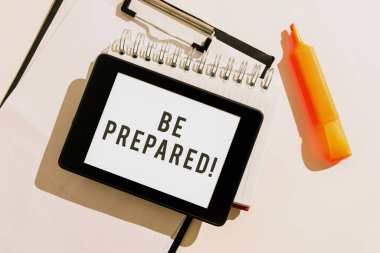 Text caption presenting Be Prepared, Business approach Getting ready for whatever will happen Plan Ahead of time Tablet With Important Message Over Clipboard, Notebook And Marker.