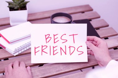 Sign displaying Best Friends, Business showcase A person you value above other persons Forever buddies Sitting Businesswoman Holding Important Message On Paper On Table.