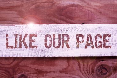 Hand writing sign Like Our Page, Business concept Follow us on the internet Contact Look for our website Important Informations Written On Piece Of Wood On Floor.