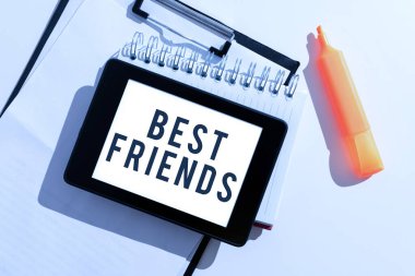 Conceptual caption Best Friends, Business overview A person you value above other persons Forever buddies Tablet With Important Message Over Clipboard, Notebook And Marker.