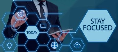 Inspiration showing sign Stay Focused, Business idea Be attentive Concentrate Prioritize the task Avoid distractions Businessman Holding Tablet And Pen Pointing On Pattern With S.