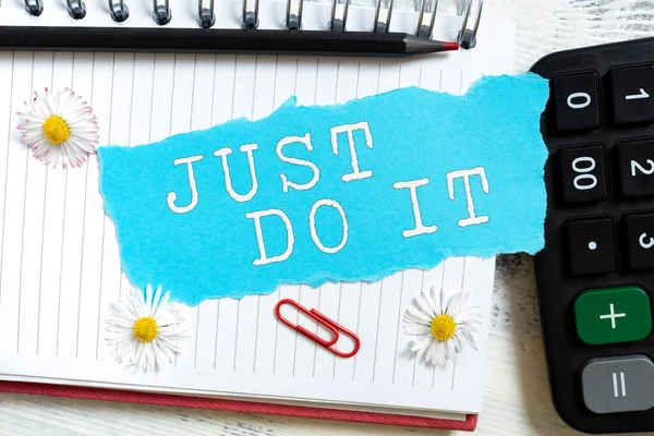 Sign displaying Just Do It, Business approach Motivation for starting doing something Have discipline New Ideas Written On Ripped Paper Over Notebook With Flowers Around.